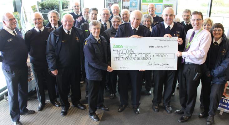 NCI St Ives proudly display their Asda collection cheque