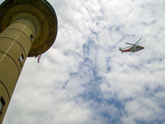 Coastguard helicopter circles the  tower 