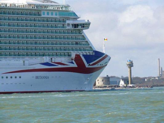 Cruise ship Britannia passes Calshot Tower viewed from the water