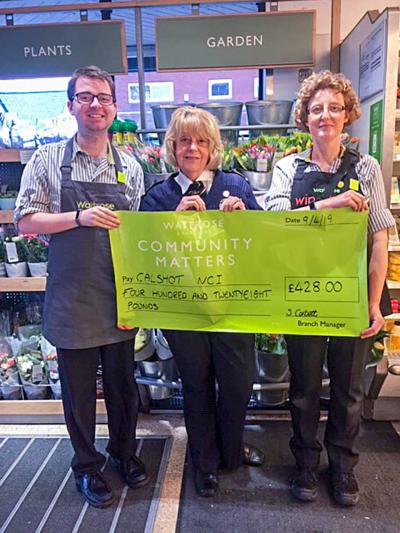 Waitrose Partners Sam and Helen present cheque to Station Manager Di Roblett 