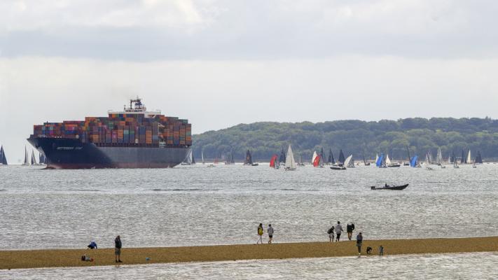 A container ship negotiates Cowes Week, Lepe Spit in foreground
