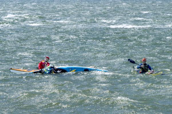 Kayakers practice rescue in rough water at Lepe Spit