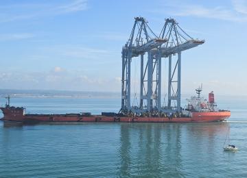 Derricks for the Container Port pass Calshot Tower